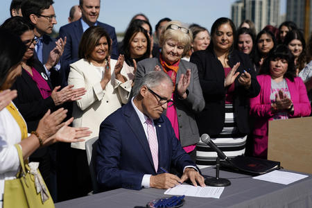 Lawmakers stand behind Gov. Inslee as he signs abortion bills
