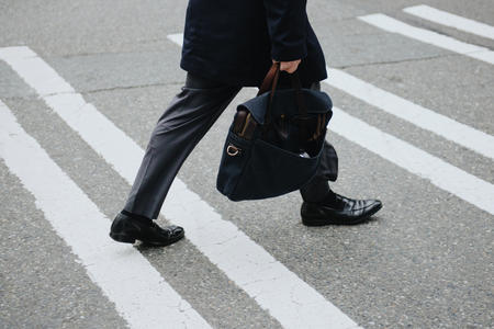 A person walking on a crosswalk 