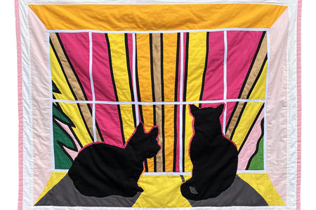 a hanging quilt with black cats in a windowsill looking out at a wildly colored sky