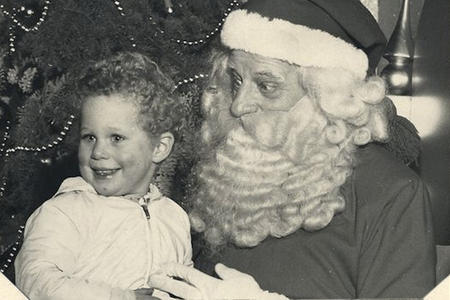 Archival image of a boy sitting on Santa’s lap