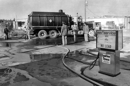 In a photo from 1979, firefighters clean up gasoline that spilled when an underground storage tank at a Texaco service station at in Aurora, Colorado