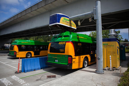 A King County Metro battery bus charges at the charging station at Eastgate Transit Center in this Aug. 1, 2018 file photo, in Bellevue, Wash.