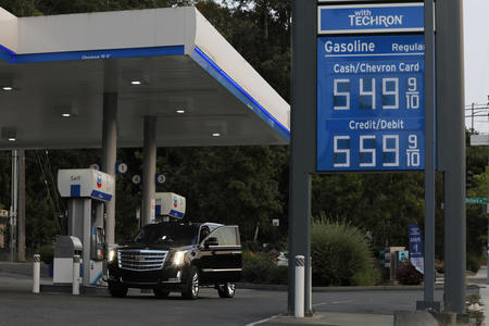 A sign at a Chevron station in Washington shows a regular price of $5.49 a gallon.