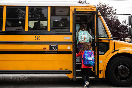 Students board the bus to Hamilton International Middle School
