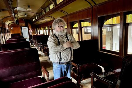 Knute Berger stands inside a vintage train car