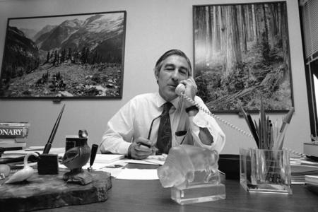 Stewart Udall sits behind the desk in his Washington law office