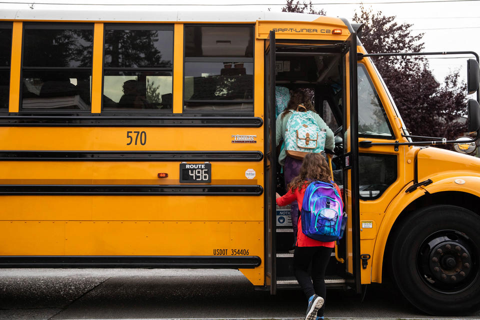 Students board the bus to Hamilton International Middle School