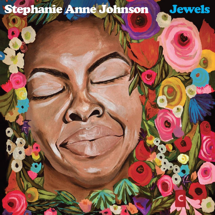 A painting of a person with their eyes closed surrounded by flowers and leaves, with the words "Stephanie Anne Johnson Jewels" at the top